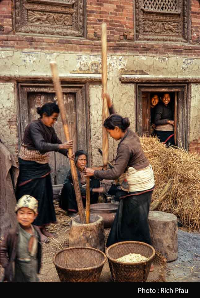 Women pounding rice to make chuira (beaten rice) image