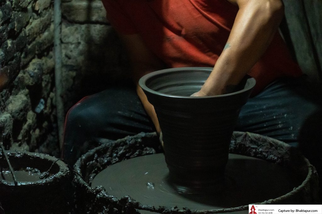 A man making a clay vase